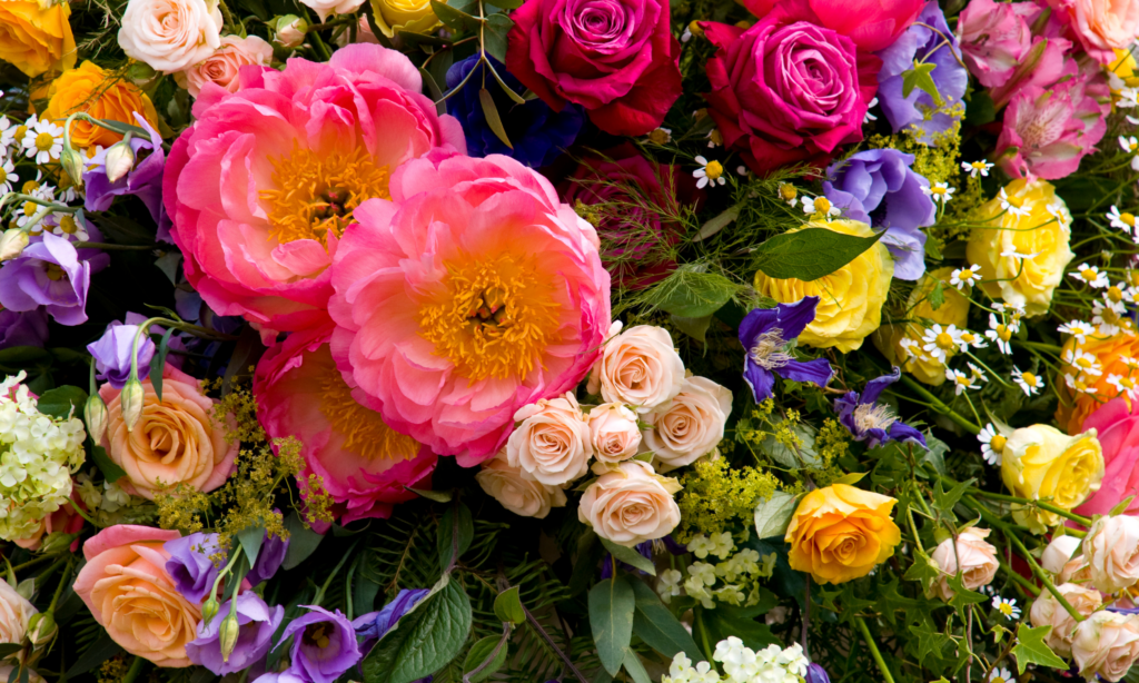 Close-up view of a flower arrangement featuring pink, purple, and yellow flowers