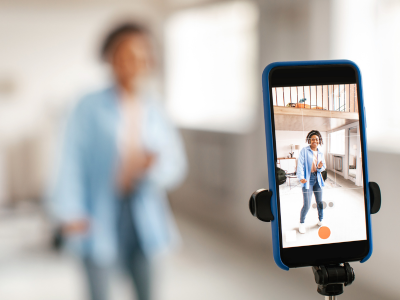 Creating Video Content for Your Floristry Business 1 A woman recording a video on her phone, which is on a tripod