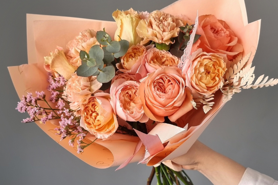 The 7 Principles of Floral Design 1 orange and pink wrapped bouquet of flowers